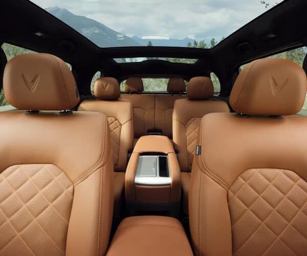 VinFast VF9 interior with cream leather seats and ambient lighting