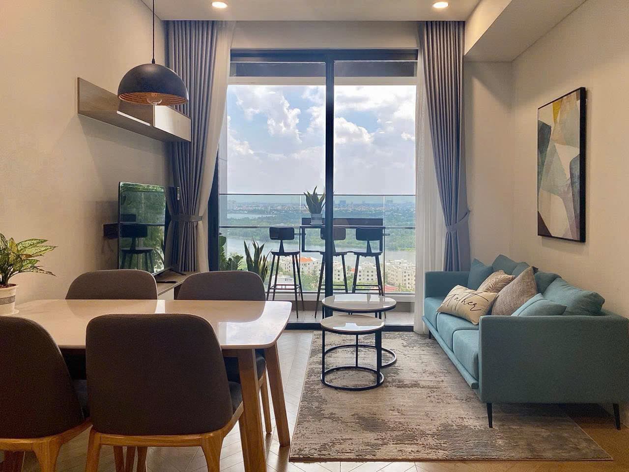 Living room with river view through floor-to-ceiling windows